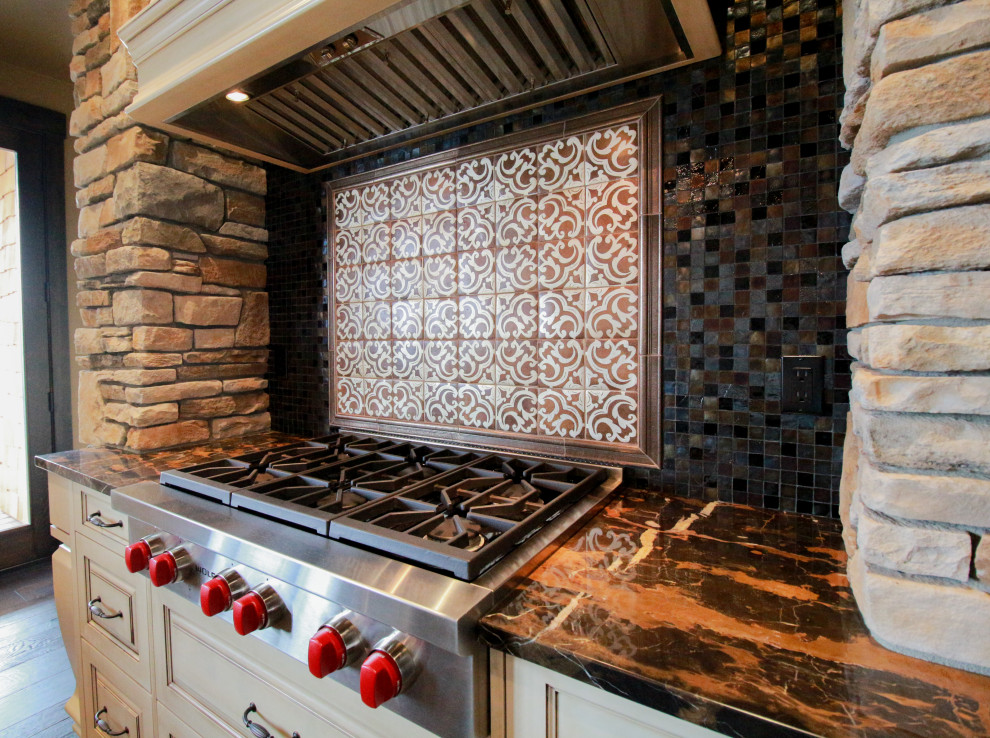 Example of a mountain style kitchen design in Seattle with multicolored backsplash, mosaic tile backsplash, stainless steel appliances and brown countertops