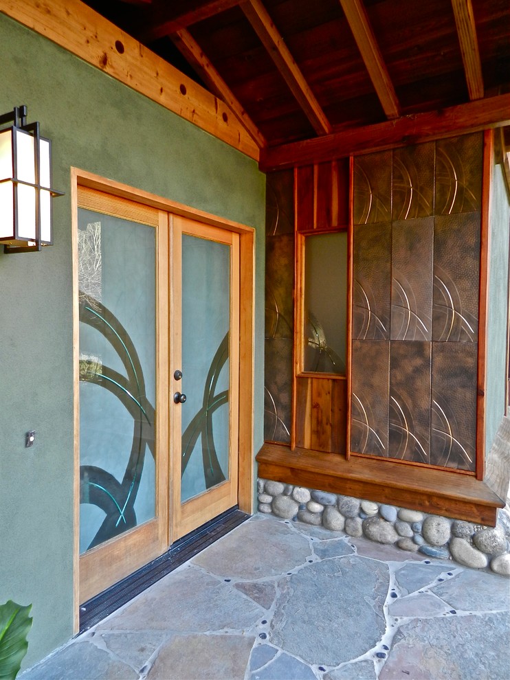 This is an example of a mid-sized asian front door in San Francisco with metallic walls, slate floors, a glass front door and a double front door.