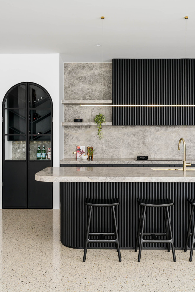 Photo of a large contemporary l-shaped open plan kitchen in Melbourne with a double-bowl sink, black cabinets, marble benchtops, grey splashback, marble splashback, black appliances, concrete floors, with island, grey floor and grey benchtop.