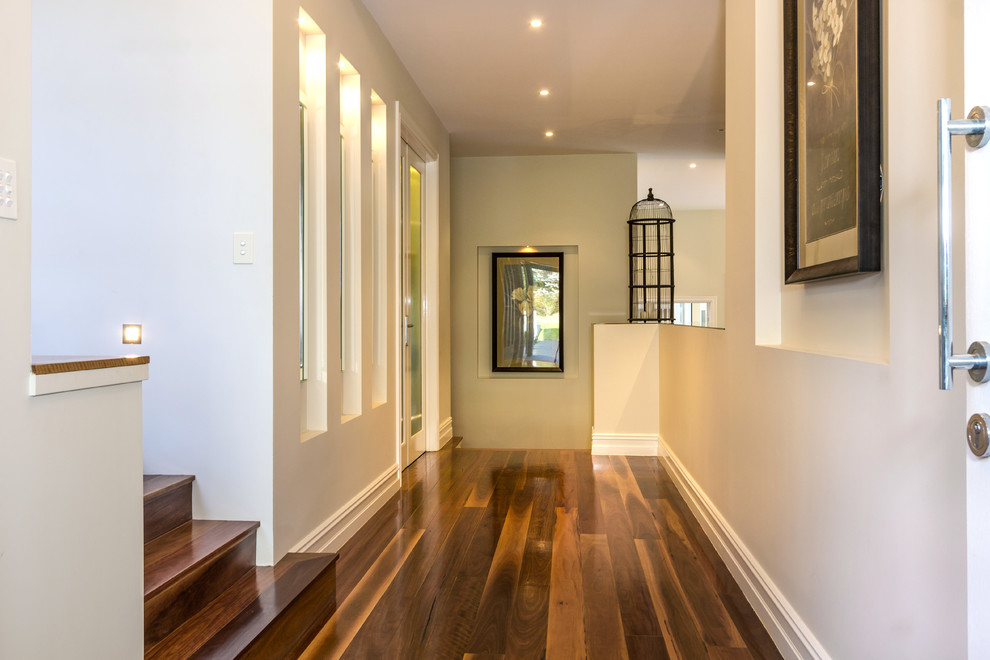 Inspiration for a mid-sized contemporary foyer in Sydney with white walls, medium hardwood floors, a double front door and a white front door.