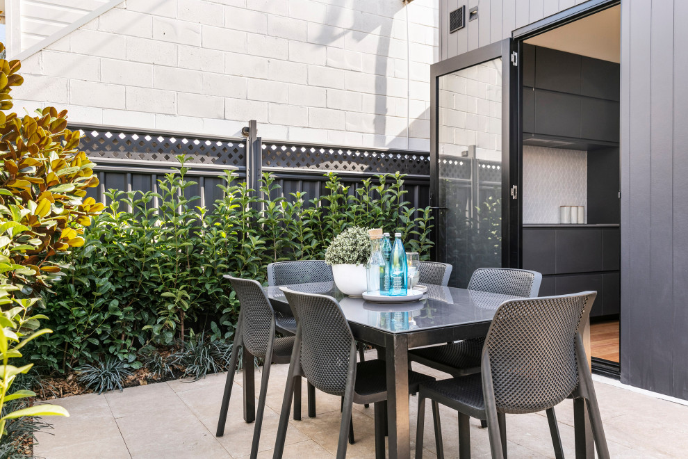 Photo of a contemporary patio in Sydney with concrete pavers and no cover.