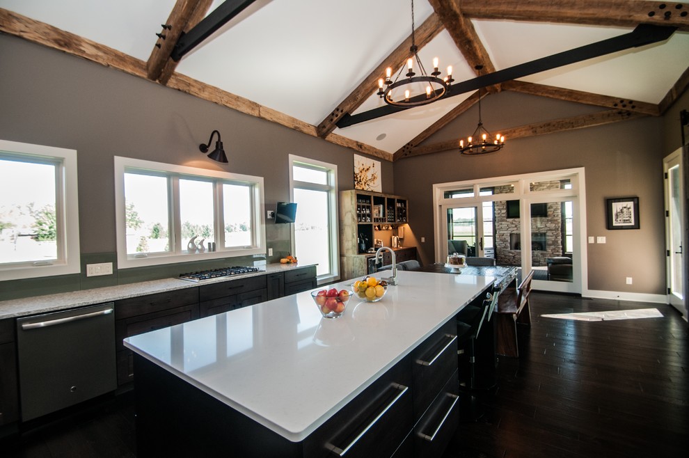 Eat-in kitchen - large rustic dark wood floor and brown floor eat-in kitchen idea with an undermount sink, flat-panel cabinets, medium tone wood cabinets, quartz countertops, green backsplash, glass sheet backsplash, stainless steel appliances and an island
