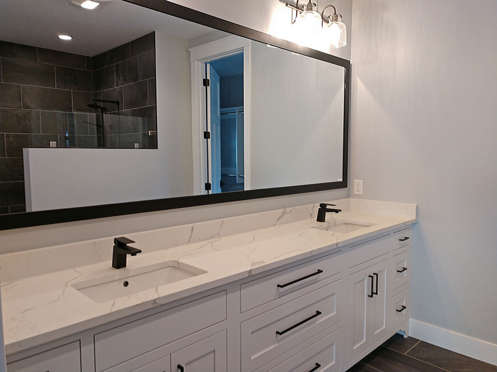 Arts and crafts master bathroom in Other with recessed-panel cabinets, white cabinets, a curbless shower, brown tile, ceramic tile, grey walls, ceramic floors, an undermount sink, engineered quartz benchtops, brown floor, an open shower and white benchtops.