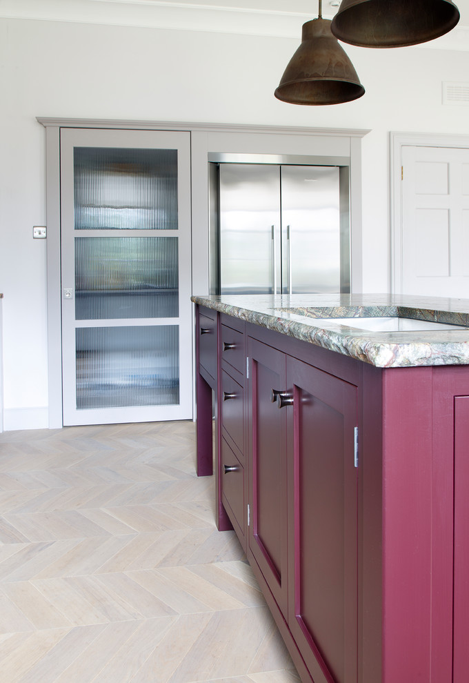 Inspiration for a mid-sized traditional open plan kitchen in Other with a double-bowl sink, shaker cabinets, purple cabinets, granite benchtops, metallic splashback, glass tile splashback, stainless steel appliances, light hardwood floors, with island, grey floor and green benchtop.