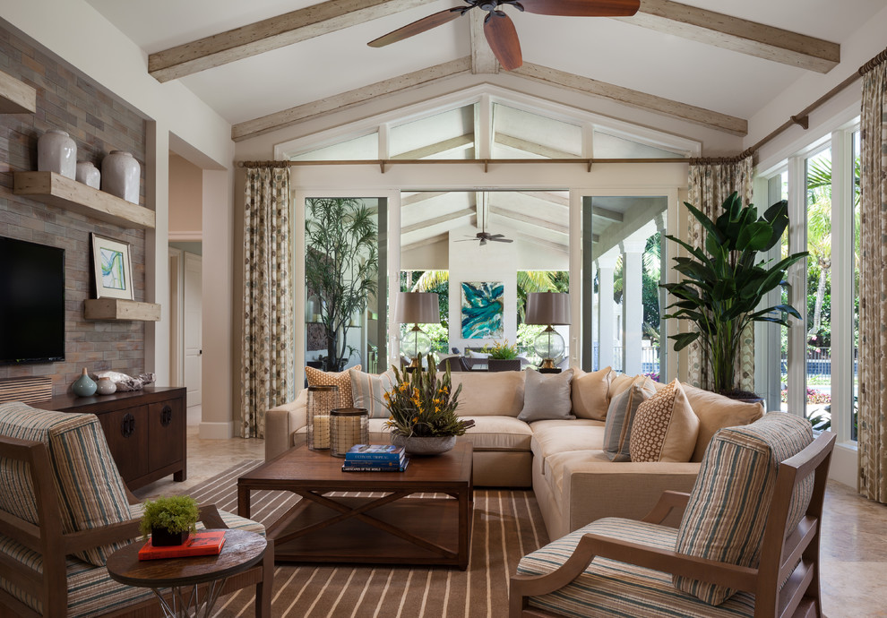 Design ideas for a transitional family room in Miami with beige walls and a wall-mounted tv.