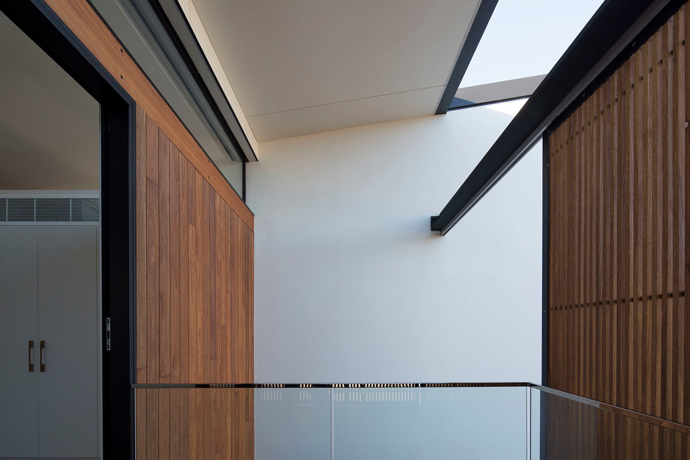 Contemporary balcony in Sydney with glass railing.