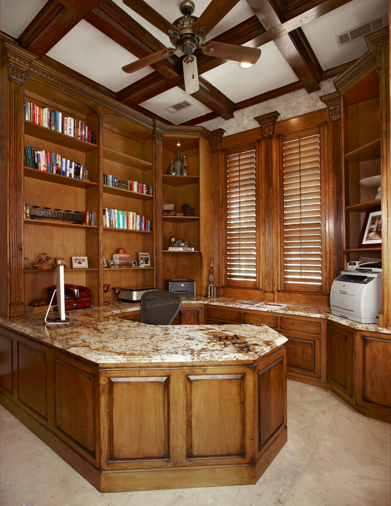This is an example of a large traditional study room in Dallas with beige walls, limestone floors, no fireplace and a built-in desk.
