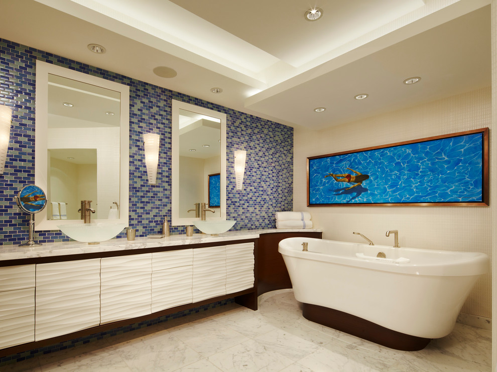 Photo of a mid-sized contemporary master bathroom in Miami with a freestanding tub, a vessel sink, dark wood cabinets, granite benchtops, blue tile, multi-coloured tile, mosaic tile, white walls, marble floors and flat-panel cabinets.