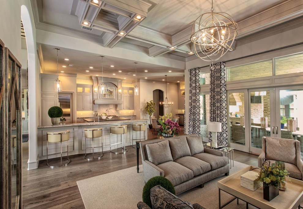 Example of a large transitional u-shaped dark wood floor and brown floor open concept kitchen design in Austin with shaker cabinets, white cabinets, granite countertops, beige backsplash, stainless steel appliances and an island