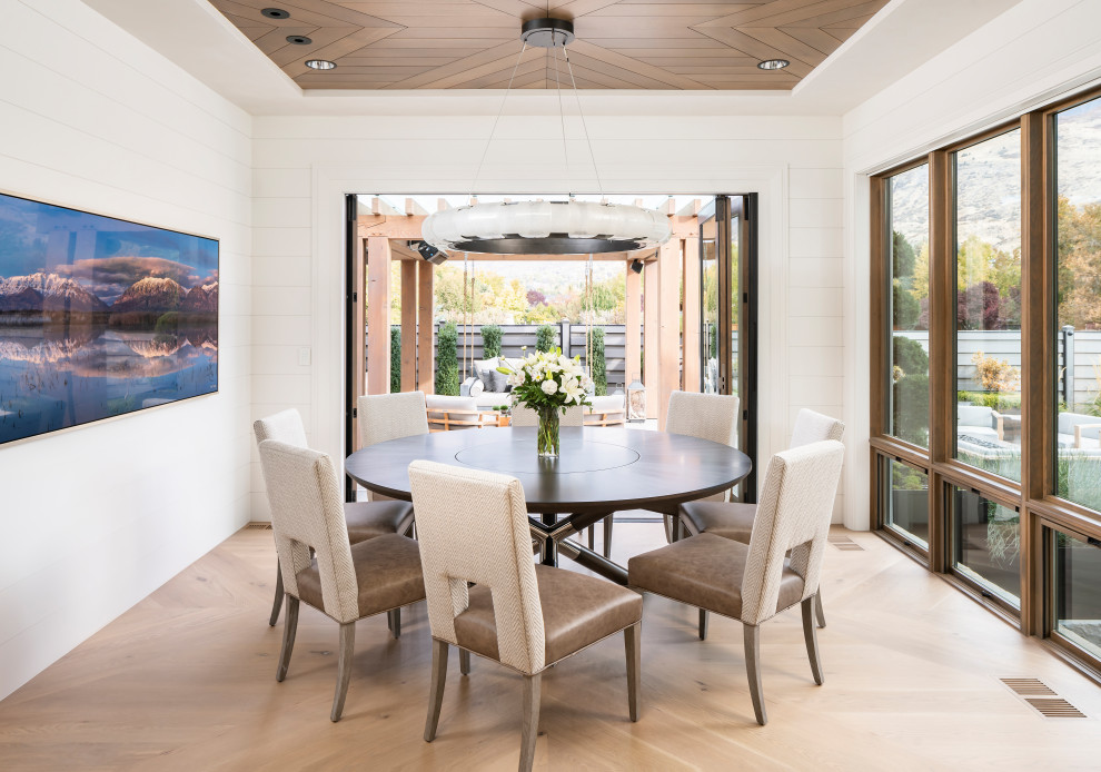 Photo of a large country open plan dining in Salt Lake City with white walls, light hardwood floors and beige floor.