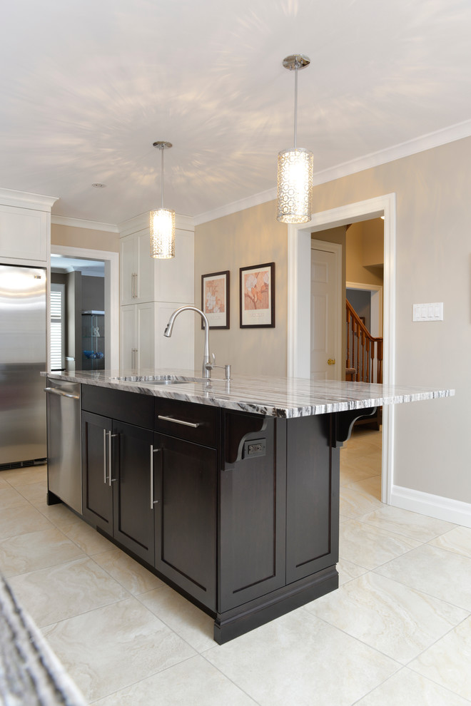 Inspiration for a large transitional u-shaped ceramic tile enclosed kitchen remodel in Toronto with an undermount sink, flat-panel cabinets, dark wood cabinets, granite countertops, beige backsplash, matchstick tile backsplash, stainless steel appliances and an island