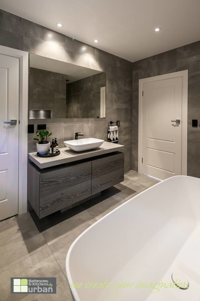 Large modern 3/4 bathroom in Adelaide with furniture-like cabinets, grey cabinets, a freestanding tub, an alcove shower, gray tile, cement tile, grey walls and ceramic floors.