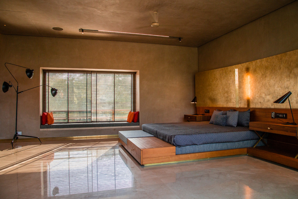 Large contemporary bedroom in Ahmedabad with brown walls, concrete floors and grey floor.