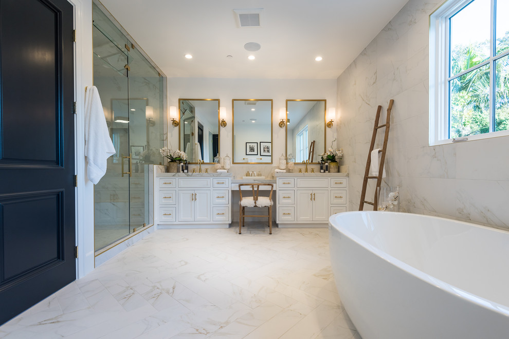 Design ideas for a large traditional master bathroom in Los Angeles with shaker cabinets, white cabinets, a freestanding tub, an alcove shower, a two-piece toilet, white tile, white walls, porcelain floors, an undermount sink, tile benchtops, white floor and a hinged shower door.