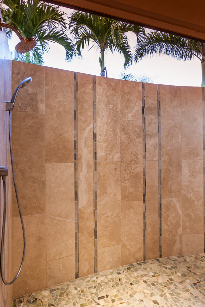 Large tropical master bathroom in Hawaii with recessed-panel cabinets, a freestanding tub, a curbless shower, beige tile, stone tile, travertine floors, an undermount sink and granite benchtops.