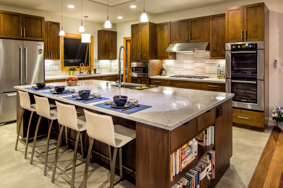 Design ideas for a transitional kitchen in San Francisco with shaker cabinets, dark wood cabinets, stainless steel appliances, stone tile splashback, white splashback, beige floor and beige benchtop.