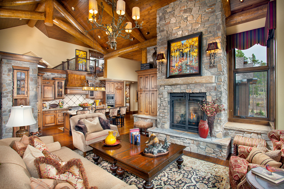 Inspiration for a country open concept living room in Denver with a stone fireplace surround.