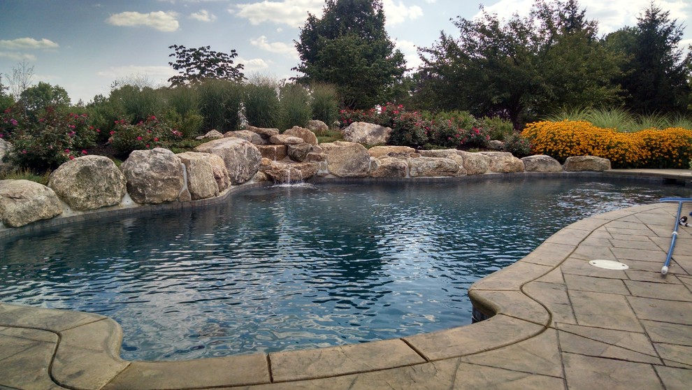 Pool - large rustic backyard custom-shaped natural pool idea in New York