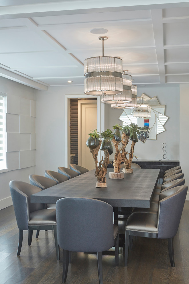 This is an example of a contemporary separate dining room in New York with grey walls and dark hardwood floors.