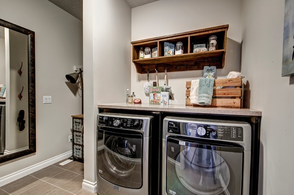 Design ideas for a small contemporary single-wall dedicated laundry room in Calgary with open cabinets, laminate benchtops, beige walls, ceramic floors, a side-by-side washer and dryer and dark wood cabinets.