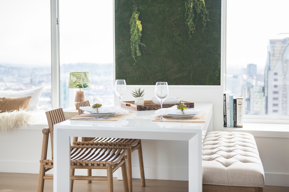 Photo of a small scandinavian open plan dining in Miami with white walls, light hardwood floors, no fireplace and beige floor.
