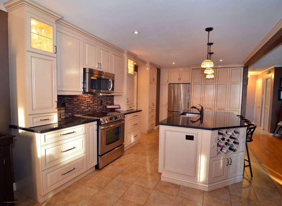 Example of a large transitional l-shaped kitchen design in Ottawa with a double-bowl sink, raised-panel cabinets, white cabinets, solid surface countertops, multicolored backsplash, mosaic tile backsplash, stainless steel appliances and an island