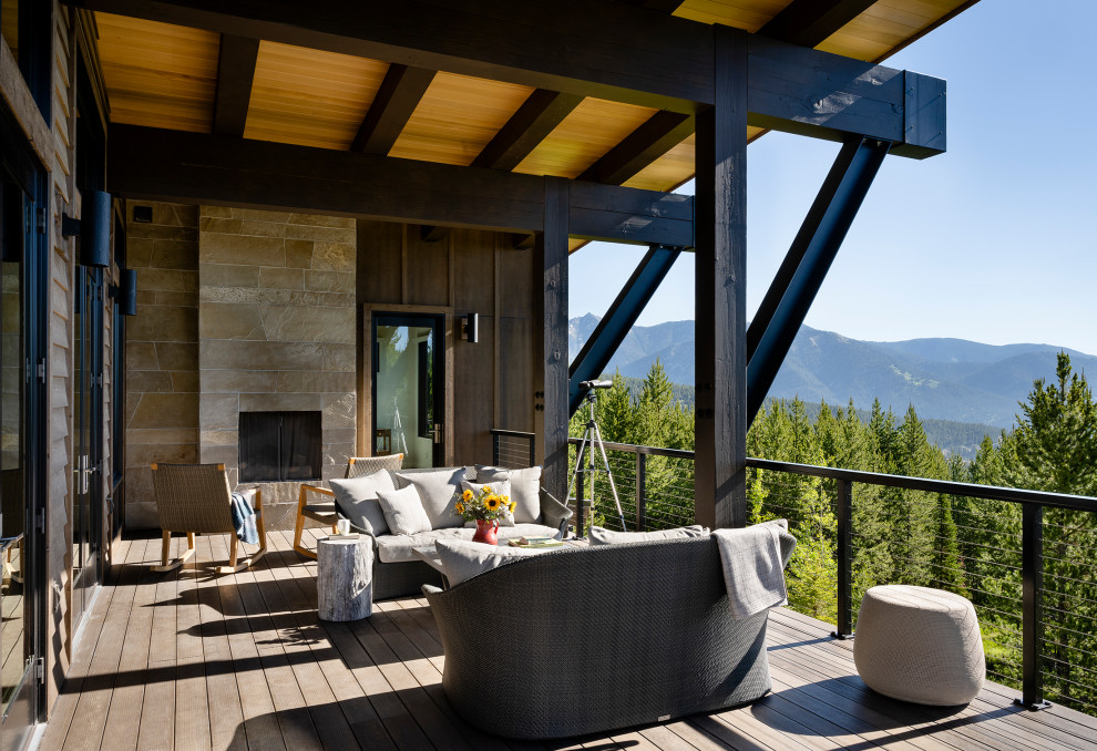 Deck - huge contemporary side yard second story cable railing deck idea with a roof extension