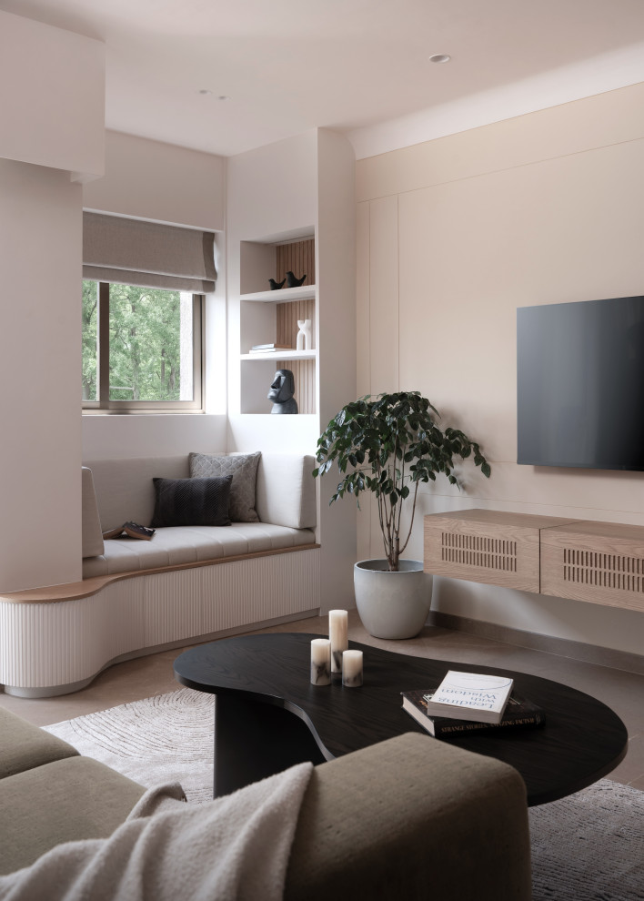 Contemporary living room in Mumbai With Beige Walls, a Wall-mounted TV and Gray.