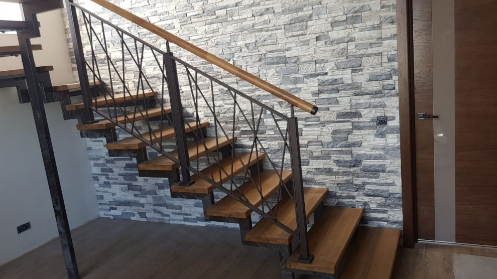 Photo of a mid-sized contemporary wood curved staircase in Other with wood risers and metal railing.