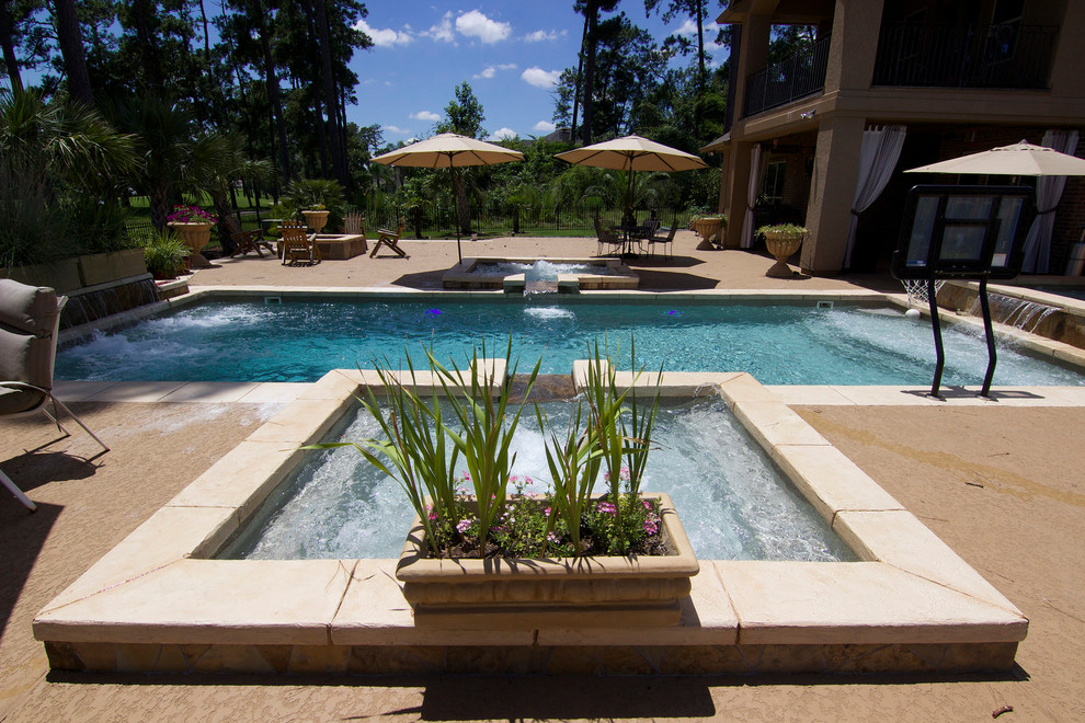 Mid-sized beach style backyard rectangular pool in Houston with a hot tub and stamped concrete.