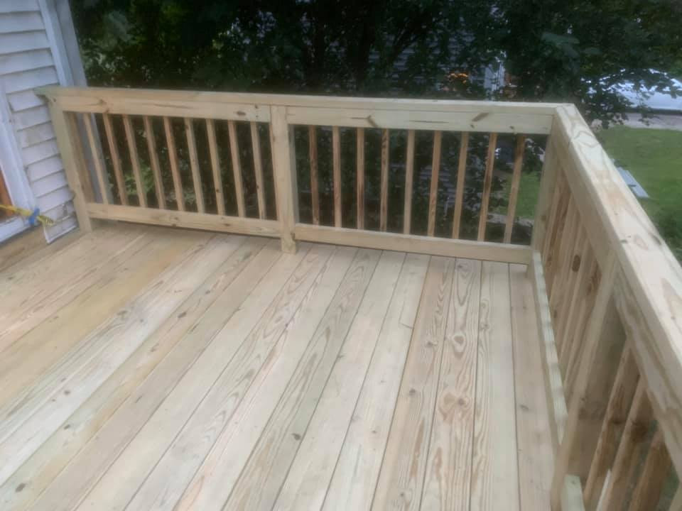 This is an example of a medium sized back wood railing terrace in Boston with no cover.