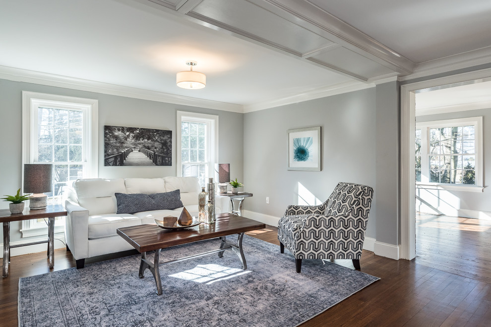 This is an example of a small contemporary formal living room in Boston with grey walls, medium hardwood floors and brown floor.