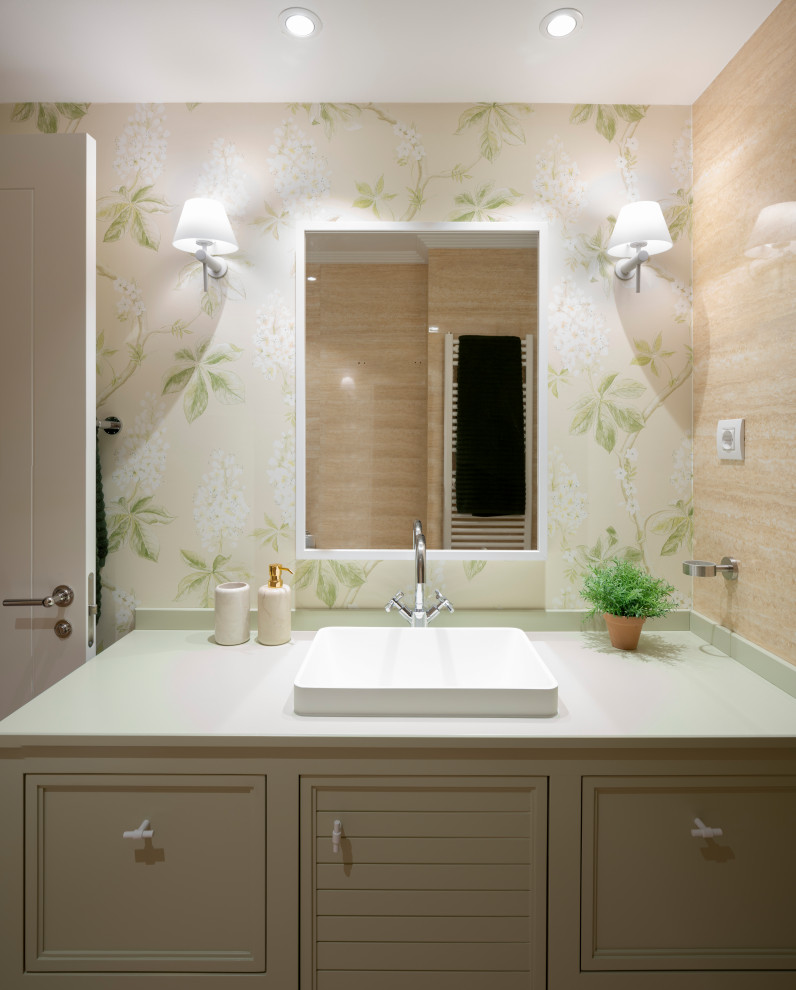 This is an example of a mid-sized transitional master bathroom in Bilbao with furniture-like cabinets, white cabinets, a curbless shower, a wall-mount toilet, beige tile, marble, beige walls, wood-look tile, an undermount sink, wood benchtops, brown floor, a hinged shower door, green benchtops, an enclosed toilet, a single vanity, a built-in vanity, recessed and wallpaper.