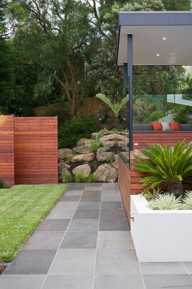 This is an example of a large contemporary backyard garden in Melbourne with decking.