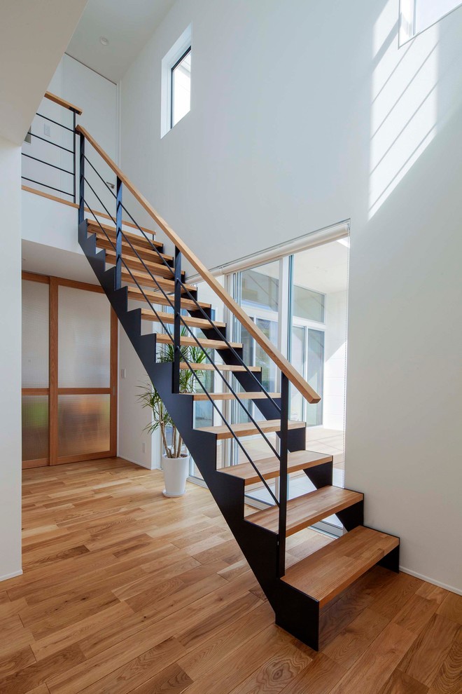 Design ideas for a mid-sized scandinavian wood straight staircase in Other with open risers and metal railing.