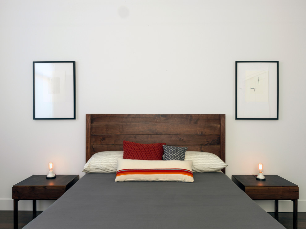 Inspiration for a transitional guest bedroom in Portland with white walls and dark hardwood floors.