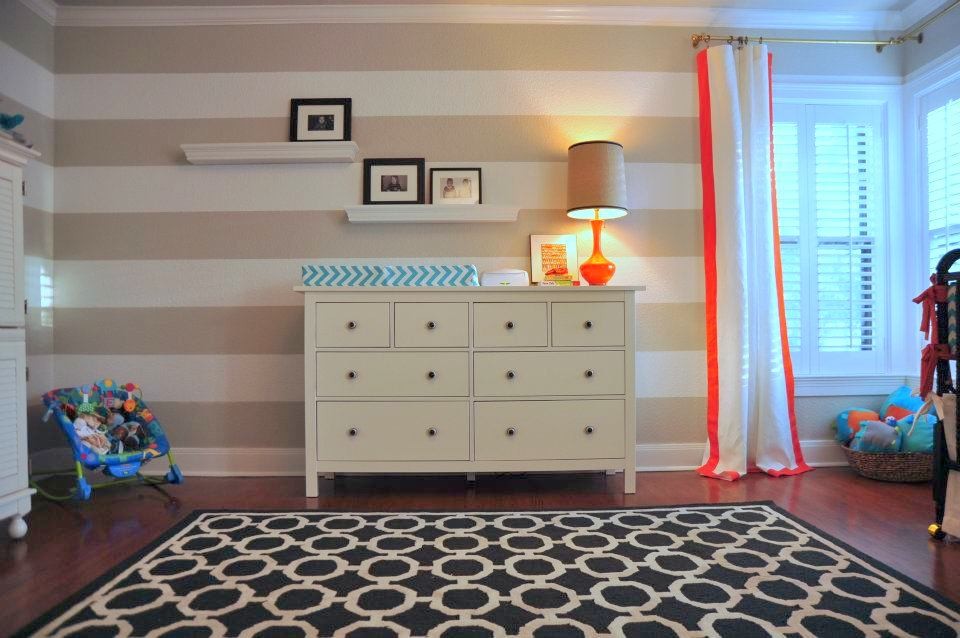 Mid-sized eclectic gender-neutral kids' room in Austin with multi-coloured walls, dark hardwood floors and brown floor.