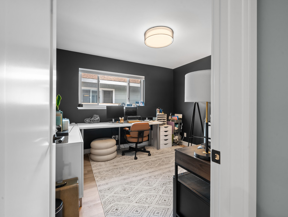 Inspiration for a mid-sized scandinavian study room in San Francisco with black walls, vinyl floors, a freestanding desk, beige floor and vaulted.