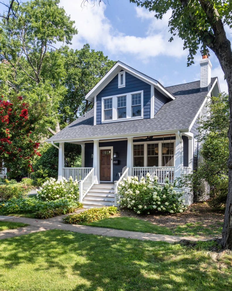 Example of a mid-sized arts and crafts blue two-story concrete fiberboard and clapboard gable roof design in DC Metro with a shingle roof and a gray roof