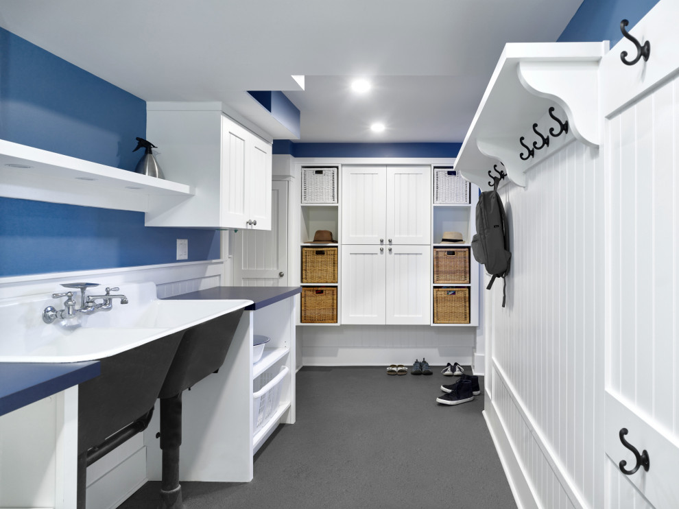 Mid-sized arts and crafts galley utility room in Vancouver with a farmhouse sink, beaded inset cabinets, white cabinets, laminate benchtops, white splashback, blue walls, a stacked washer and dryer, grey floor, blue benchtop and decorative wall panelling.