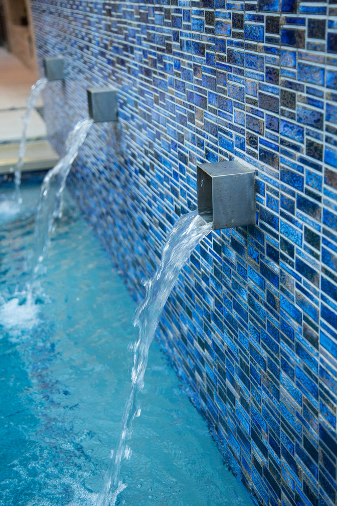 Inspiration for a small contemporary courtyard rectangular pool in Dallas with a water feature and natural stone pavers.