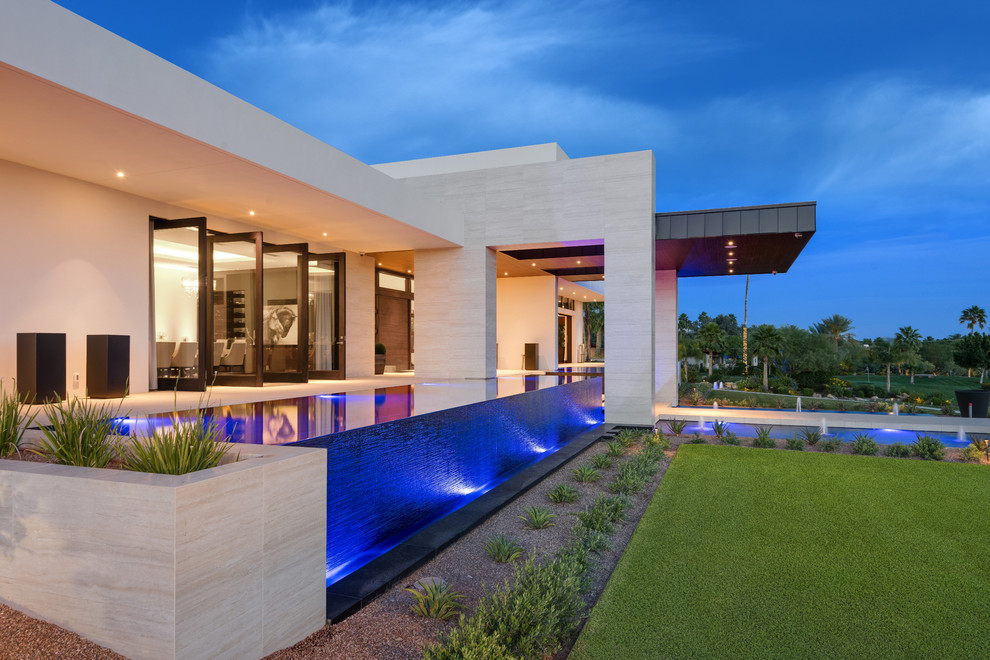 Inspiration for an expansive contemporary rooftop custom-shaped infinity pool in Phoenix with a water feature and tile.