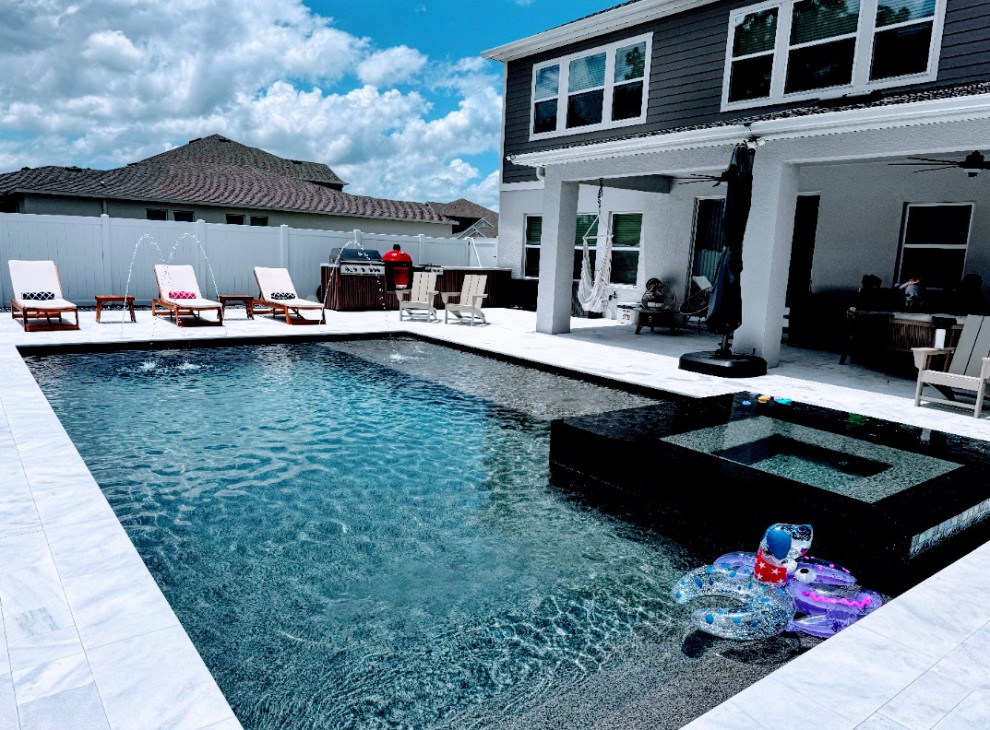 St. Cloud pool with overflow perimeter spa and sun shelf