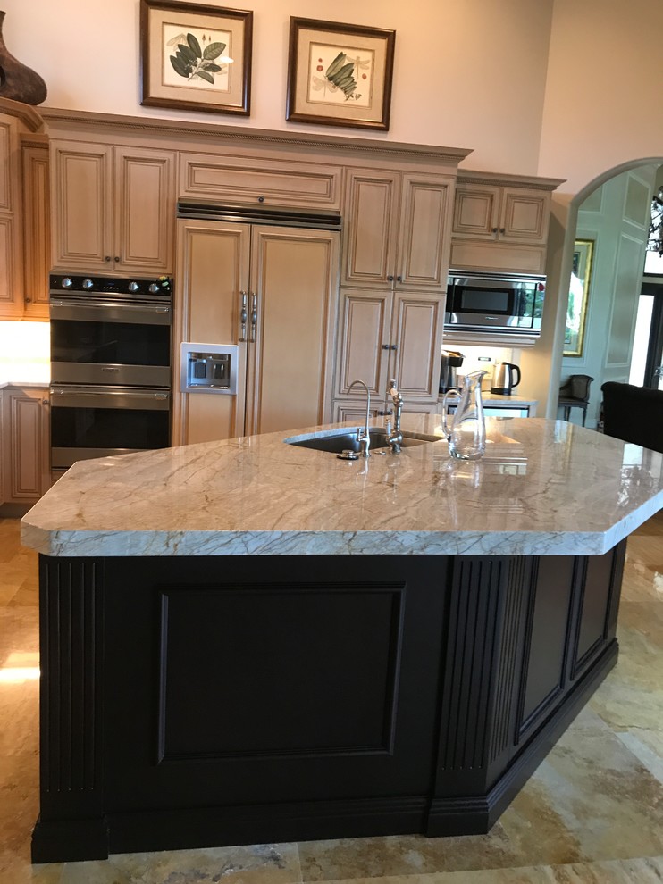 Kitchen - mid-sized transitional l-shaped brown floor kitchen idea in Miami with an undermount sink, raised-panel cabinets, light wood cabinets, paneled appliances and an island