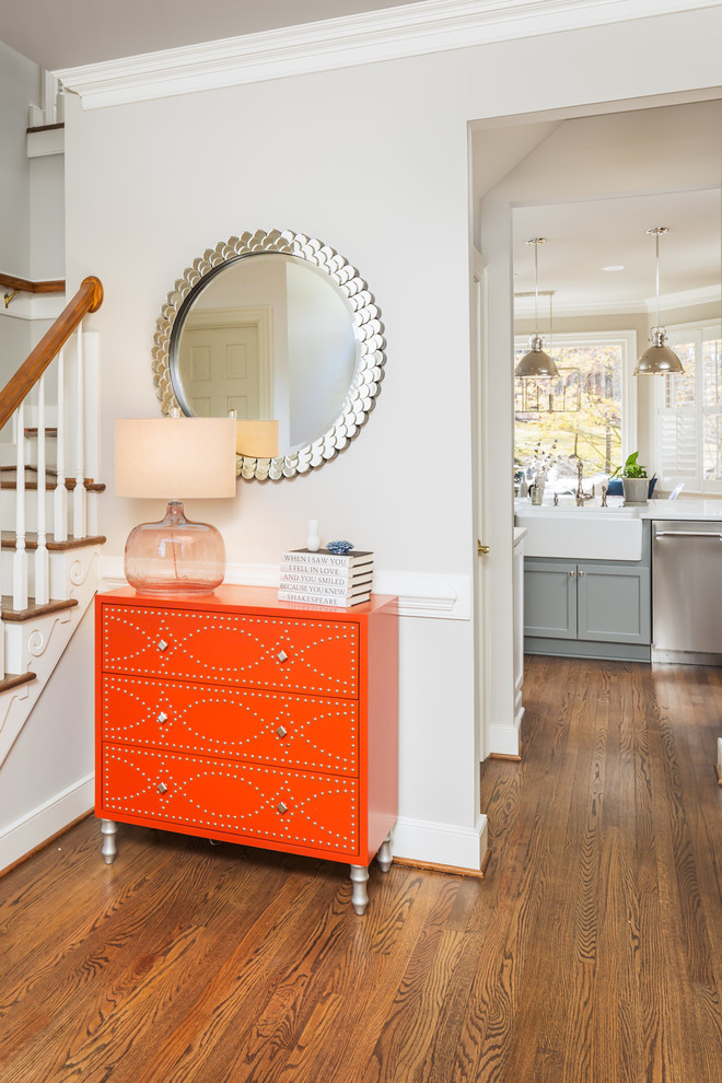 Example of a mid-sized transitional medium tone wood floor foyer design in Raleigh with gray walls and a black front door