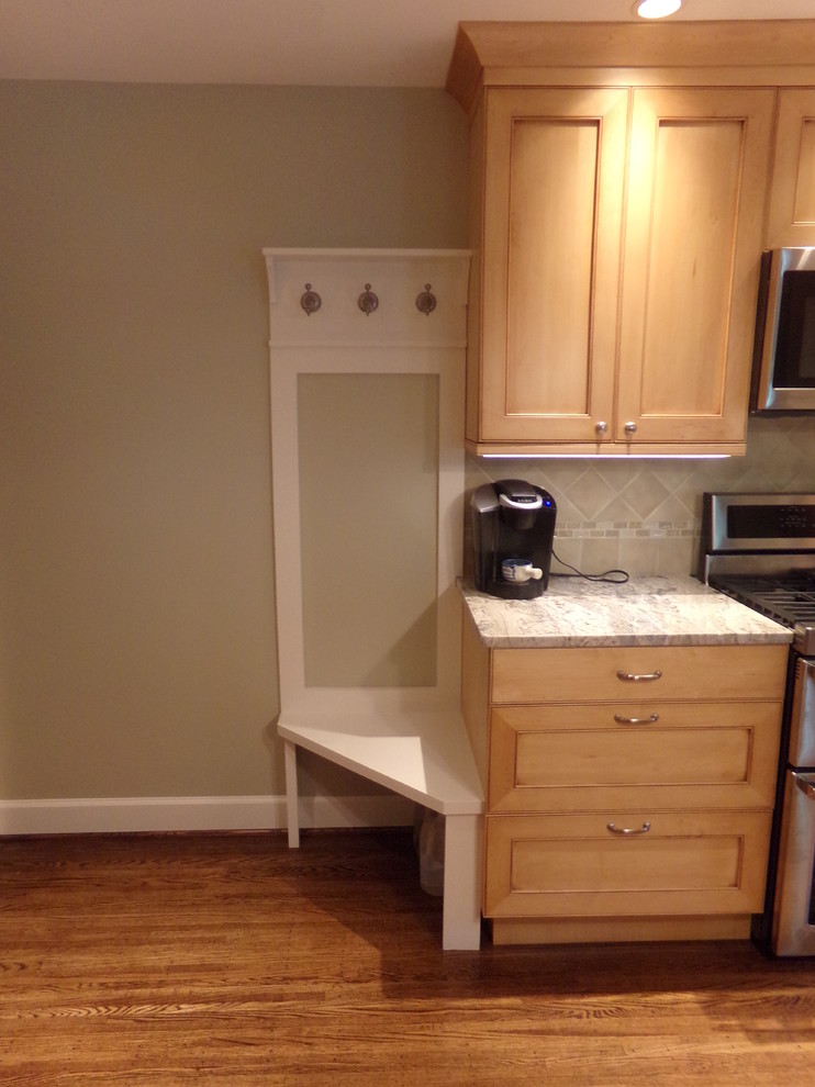 Home design - mid-sized transitional l-shaped medium tone wood floor home design idea in New York with an undermount sink, raised-panel cabinets, light wood cabinets, granite countertops, beige backsplash, subway tile backsplash, stainless steel appliances and an island