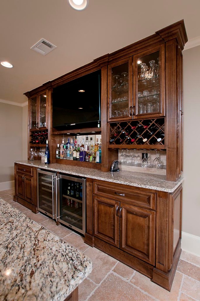 Design ideas for a mid-sized traditional galley seated home bar in Atlanta with an undermount sink, raised-panel cabinets, medium wood cabinets, quartz benchtops, terra-cotta floors, beige floor and multi-coloured benchtop.