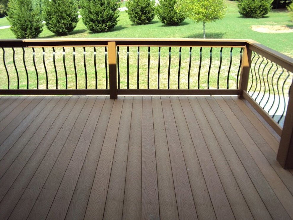 Inspiration for a transitional backyard deck in Nashville with a roof extension.