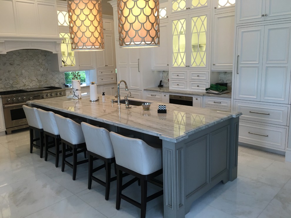 Inspiration for a large transitional u-shaped marble floor and white floor eat-in kitchen remodel in Miami with an undermount sink, recessed-panel cabinets, white cabinets, marble countertops, gray backsplash, stone tile backsplash, paneled appliances and an island
