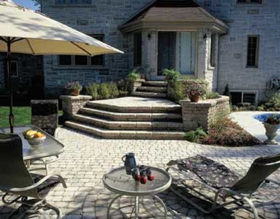 This is an example of a traditional backyard patio in Raleigh with brick pavers and no cover.